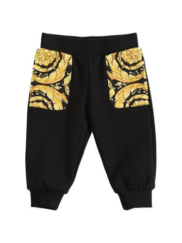 Pantalones De Algodón Con Estampado - VERSACE - Modalova