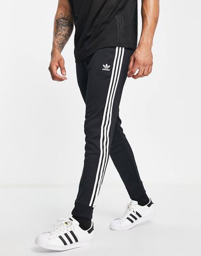 Adicolor - Joggers skinny neri con 3 strisce - BLACK - adidas Originals - Modalova