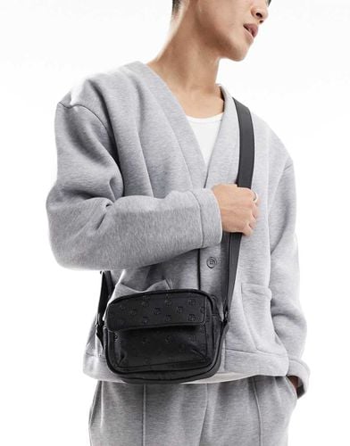 Borsa a tracolla nera in pelle sintetica con dettagli goffrati - ASOS DESIGN - Modalova