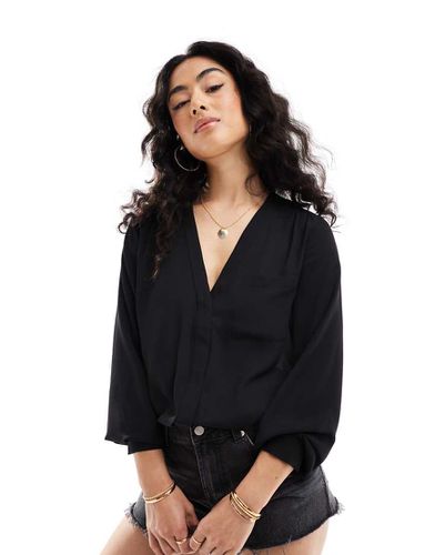 Blusa a maniche lunghe nera con tasca - ASOS DESIGN - Modalova