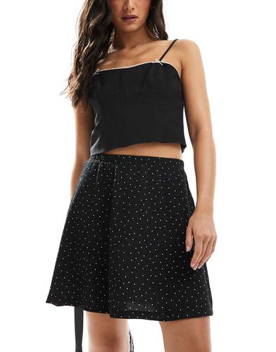 Gonna midi nera a pois - ASOS DESIGN - Modalova