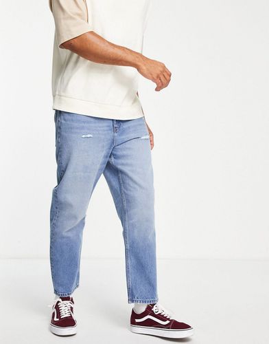 Jeans comodi affusolati lavaggio medio vintage - ASOS DESIGN - Modalova