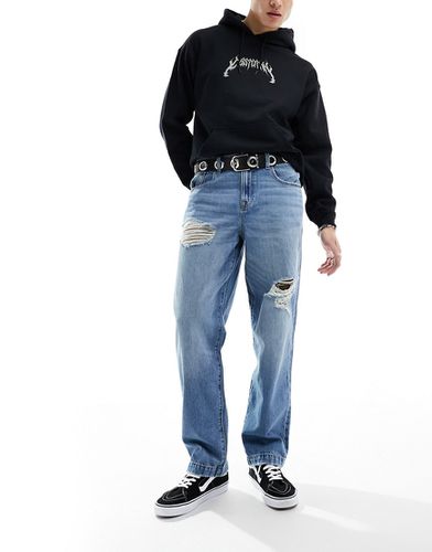 Jeans ampi lavaggio medio con strappi - ASOS DESIGN - Modalova