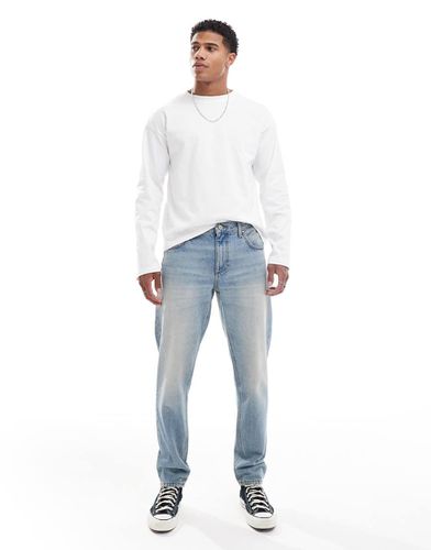 Jeans affusolati lavaggio medio tinto - ASOS DESIGN - Modalova