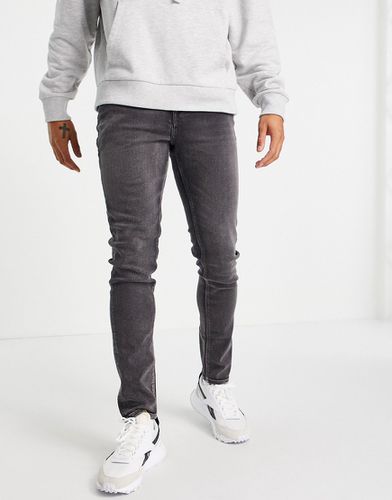 Jeans skinny nero délavé - ASOS DESIGN - Modalova