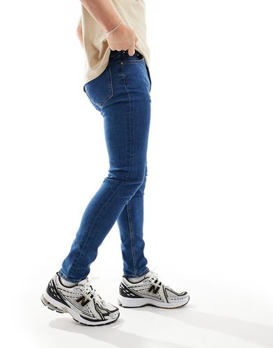Jeans skinny lavaggio medio - ASOS DESIGN - Modalova