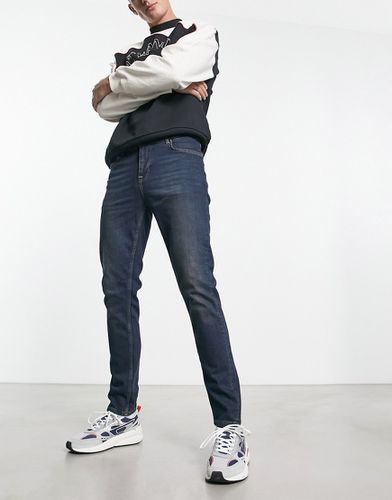 Jeans skinny lavaggio scuro in Y2k - ASOS DESIGN - Modalova