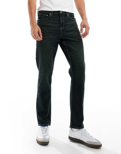 Jeans slim slavato con tintura verde - ASOS DESIGN - Modalova