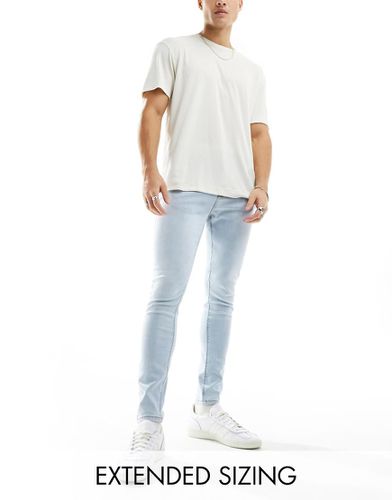 Jeans spray on power stretch lavaggio chiaro - ASOS DESIGN - Modalova