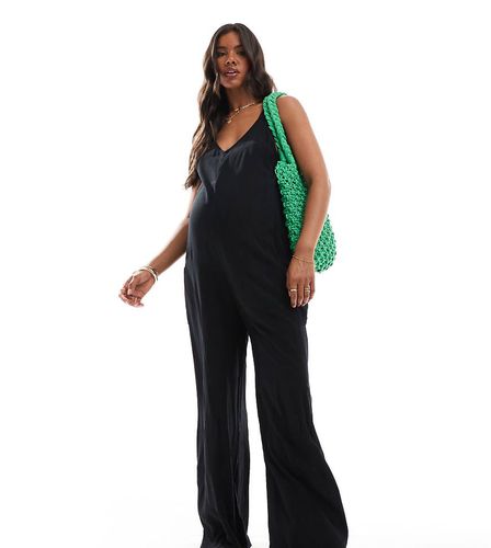 Maternity - Tuta jumpsuit da spiaggia nera con tasche - ASOS DESIGN - Modalova