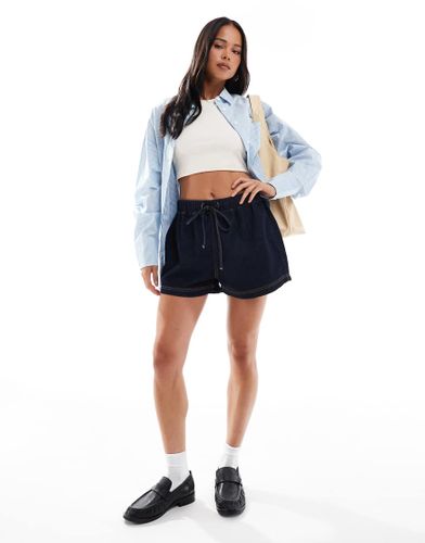 Short à enfiler en denim façon jogger - Délavage brut - Asos Design - Modalova