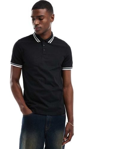 Polo in piqué nera con profili a contrasto - ASOS DESIGN - Modalova