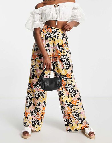 Pantaloni a pieghe arancioni a fiori - ASOS DESIGN - Modalova