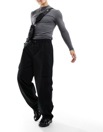 Pantaloni ampi stile cargo con elastico in vita neri - ASOS DESIGN - Modalova