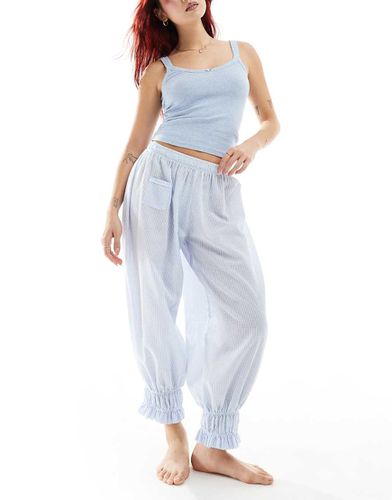 Set con canotta traforata e pantaloni lunghi chiaro a righe - Free People - Modalova