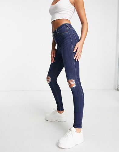 Jeans skinny color indaco con strappi - Hollister - Modalova