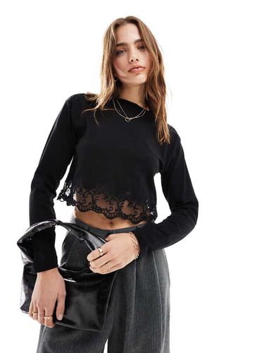 Top a maniche lunghe con bordo in pizzo - Miss Selfridge - Modalova