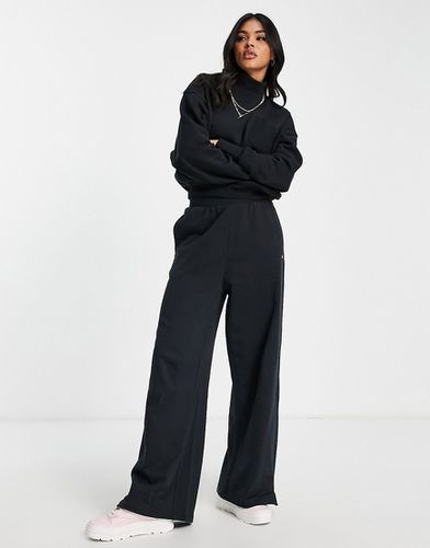 Pantaloni a vita alta con fondo ampio neri - Reebok - Modalova