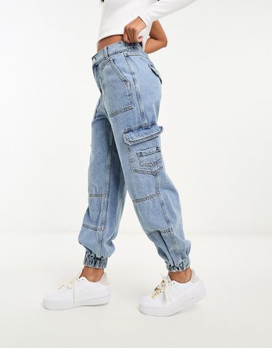 Jeans cargo chiaro con fondo elasticizzato - River Island - Modalova