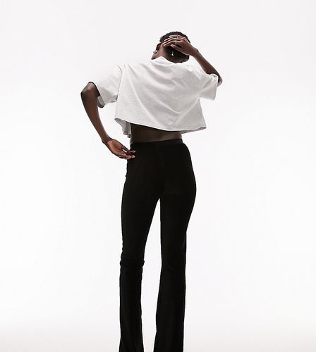Pantaloni a zampa elasticizzati in velluto a coste neri - Topshop Tall - Modalova