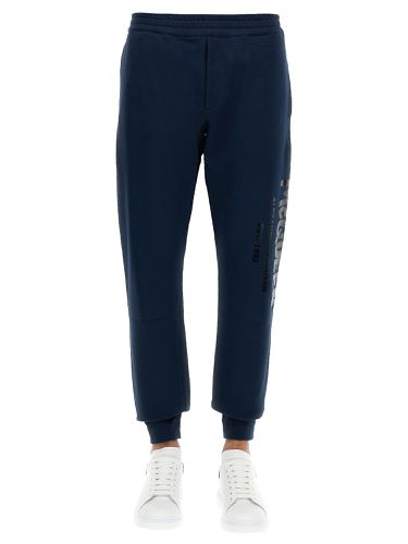 Jogging pants with graffiti logo - alexander mcqueen - Modalova