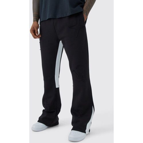 Pantaloni tuta con inserti in tessuto grezzo e applique - boohoo - Modalova