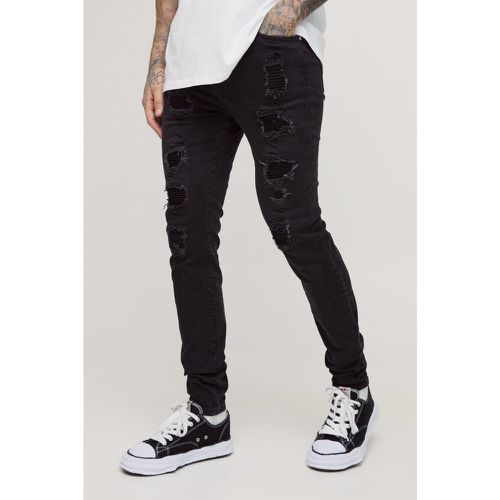 Jeans Tall Skinny Fit in denim Stretch con strappi e pieghe sul fondo - boohoo - Modalova