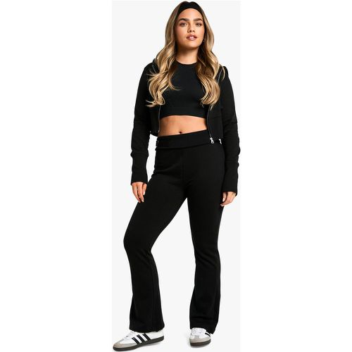 Tuta sportiva Petite con pantaloni a zampa, zip e fondo ampio - boohoo - Modalova