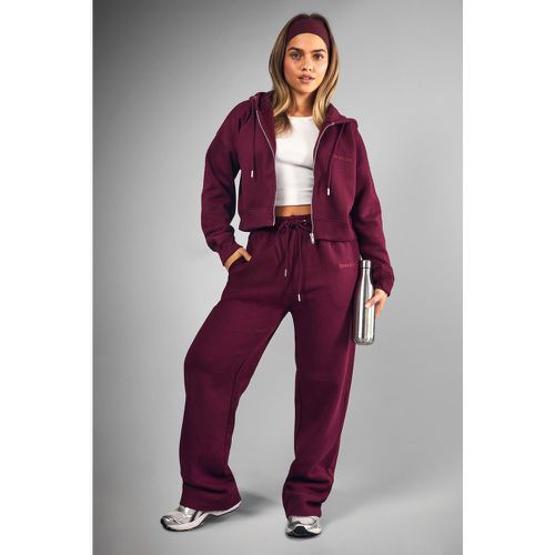 Tuta sportiva Petite con gamba dritta e zip - boohoo - Modalova