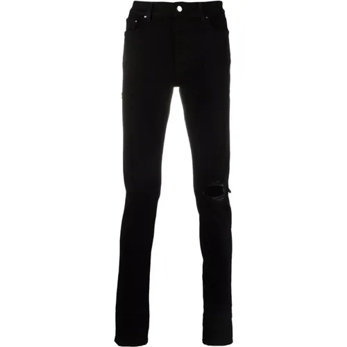Schwarze zerrissene Skinny Jeans - Amiri - Modalova