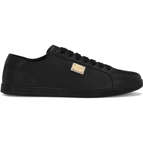 Schwarze flache Schuhe mit goldfarbenem Logo - Dolce & Gabbana - Modalova