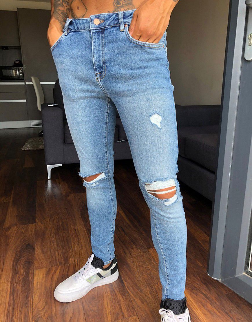 Jeans effetto spray vintage power stretch lavaggio medio con strappi alle ginocchia - ASOS DESIGN - Modalova