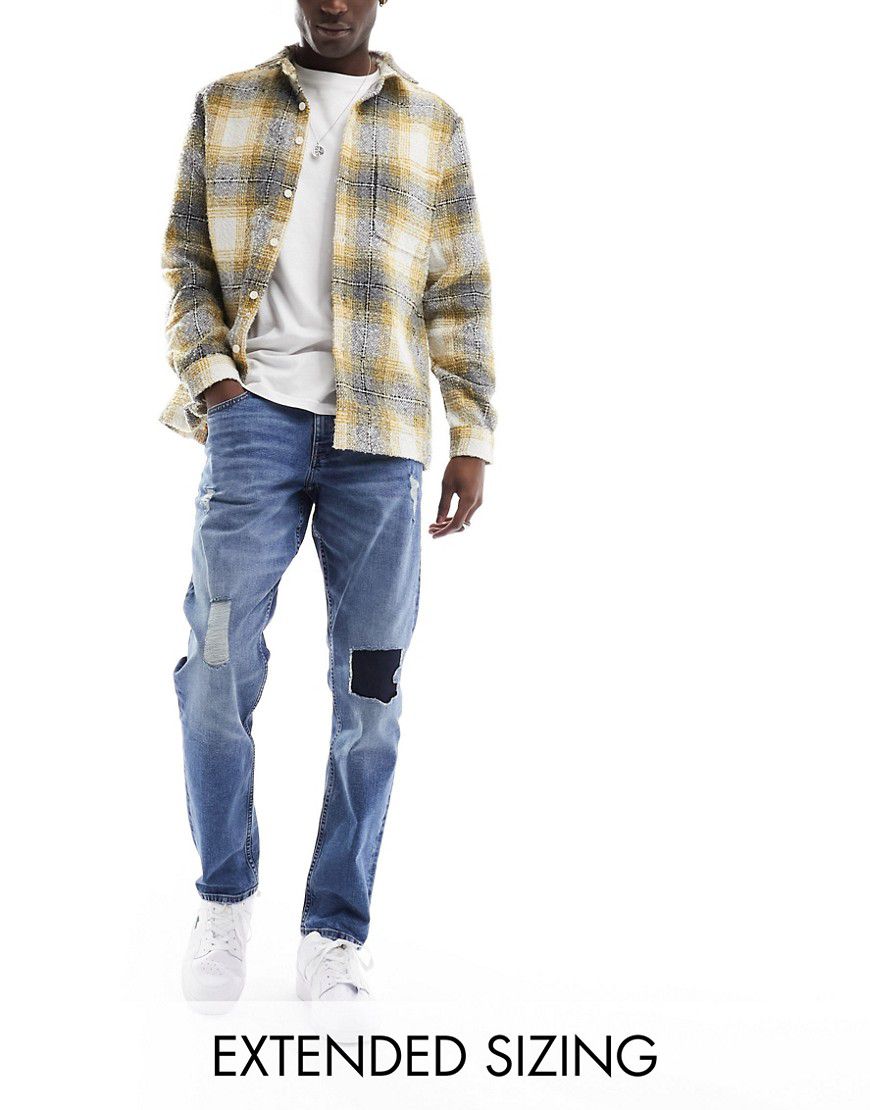 Jeans elasticizzati slim medio con strappi - ASOS DESIGN - Modalova