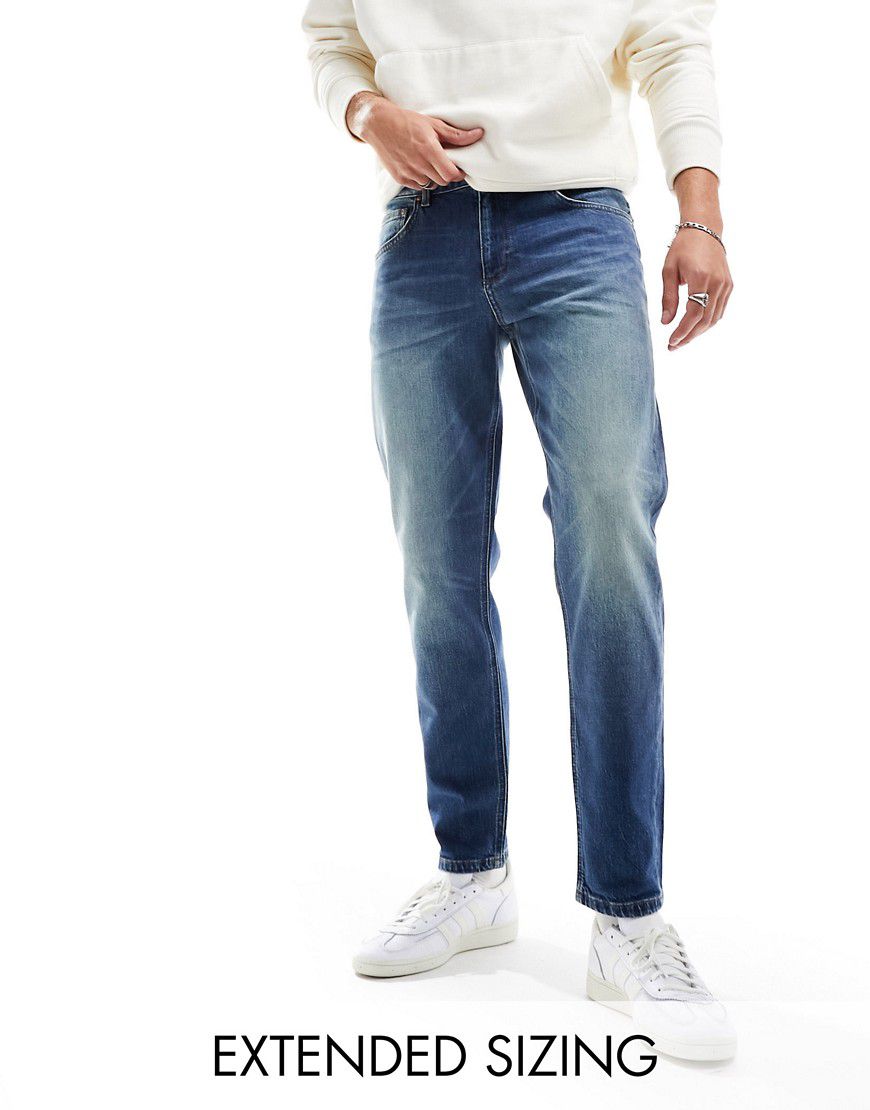 Jeans stretch affusolati lavaggio medio tinto - ASOS DESIGN - Modalova
