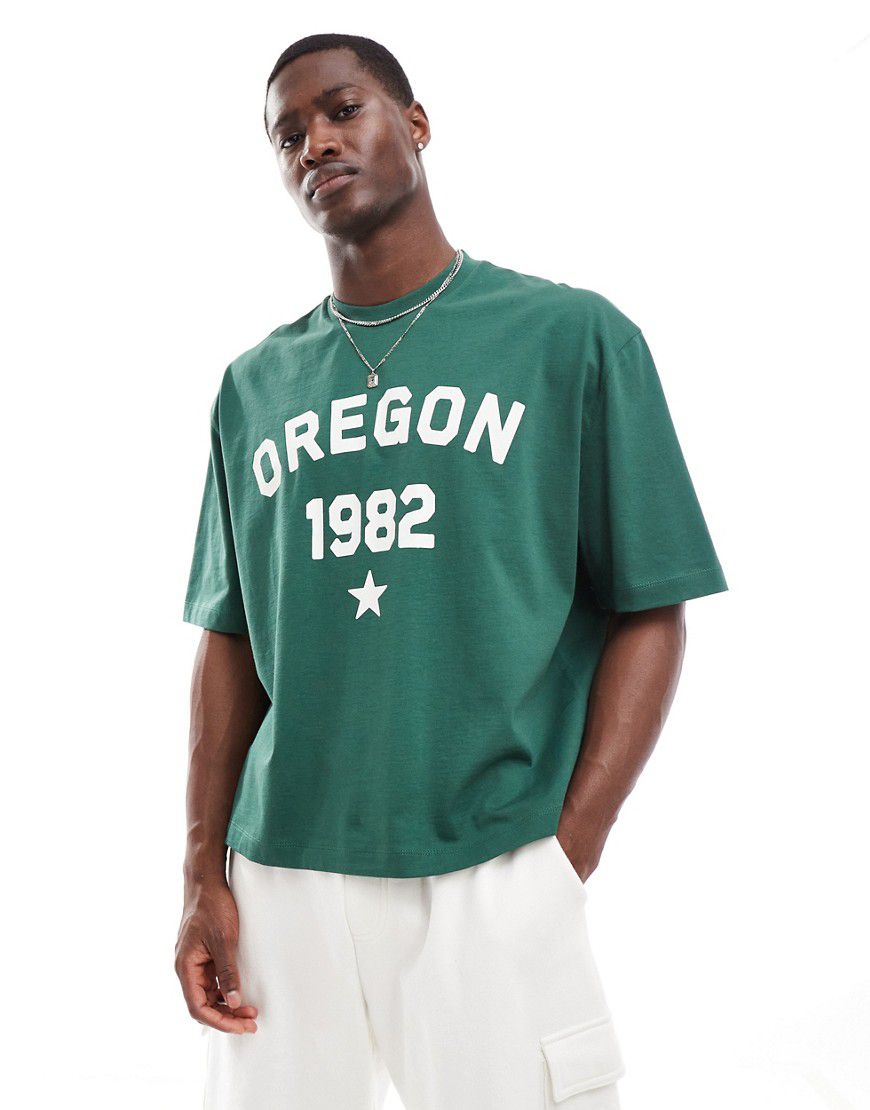 T-shirt oversize squadrata scuro con stampa Oregon sul davanti e fettuccia sulle spalle - ASOS DESIGN - Modalova